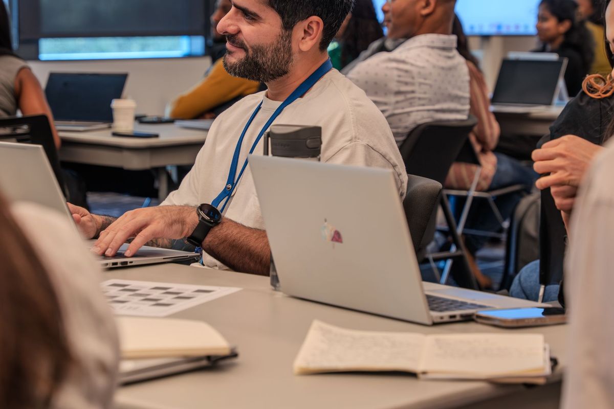 Un taller grupal: personas trabajan con sus computadores en una sala